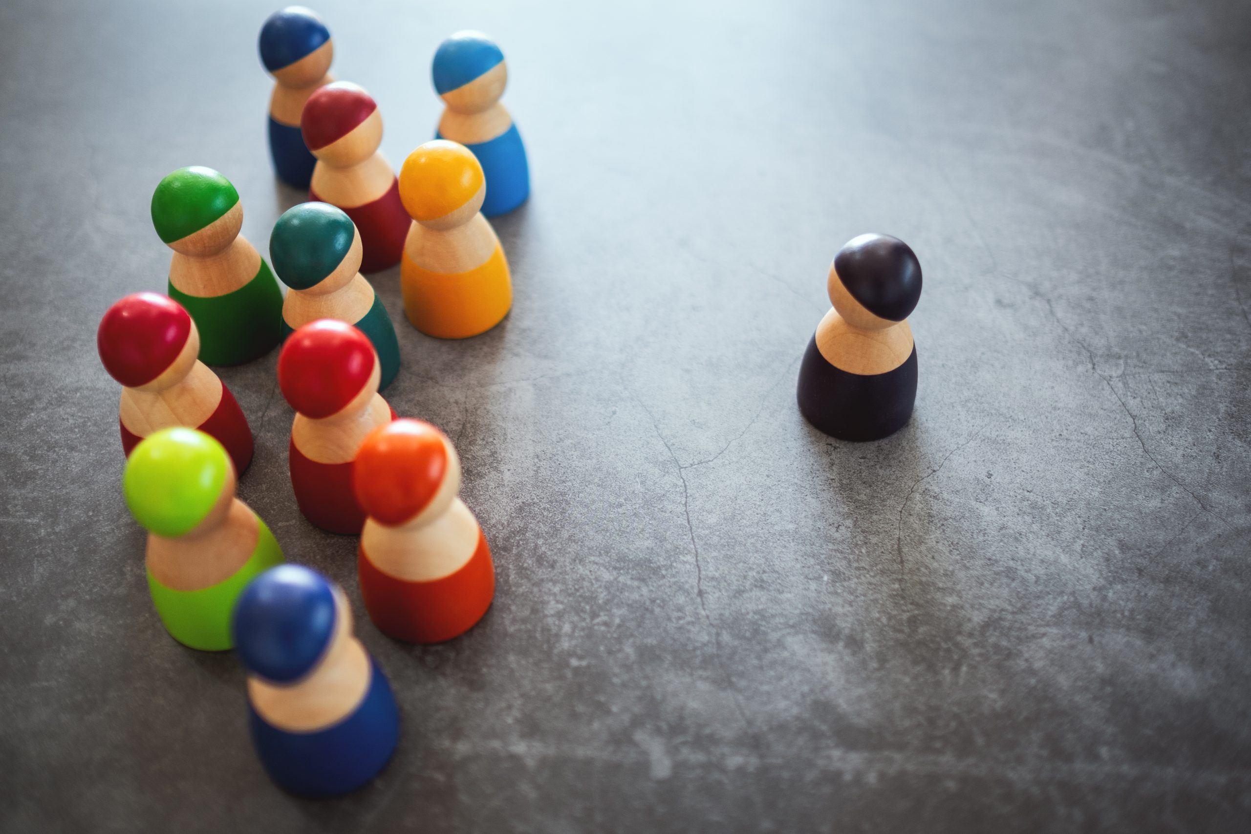 One of wooden figurine standing in front of a group of other for
